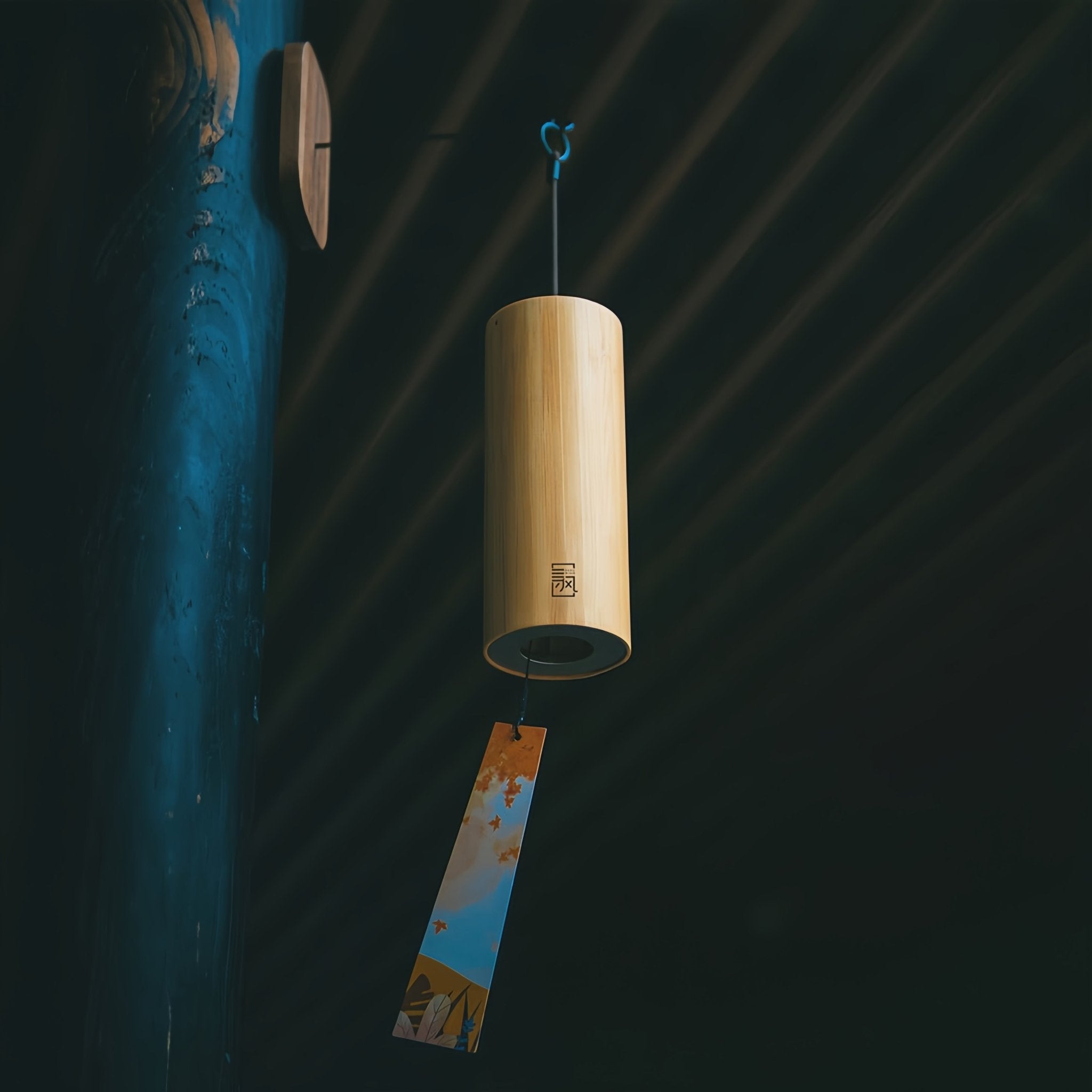Bamboo harmonic wind chime hanging against a blue background.