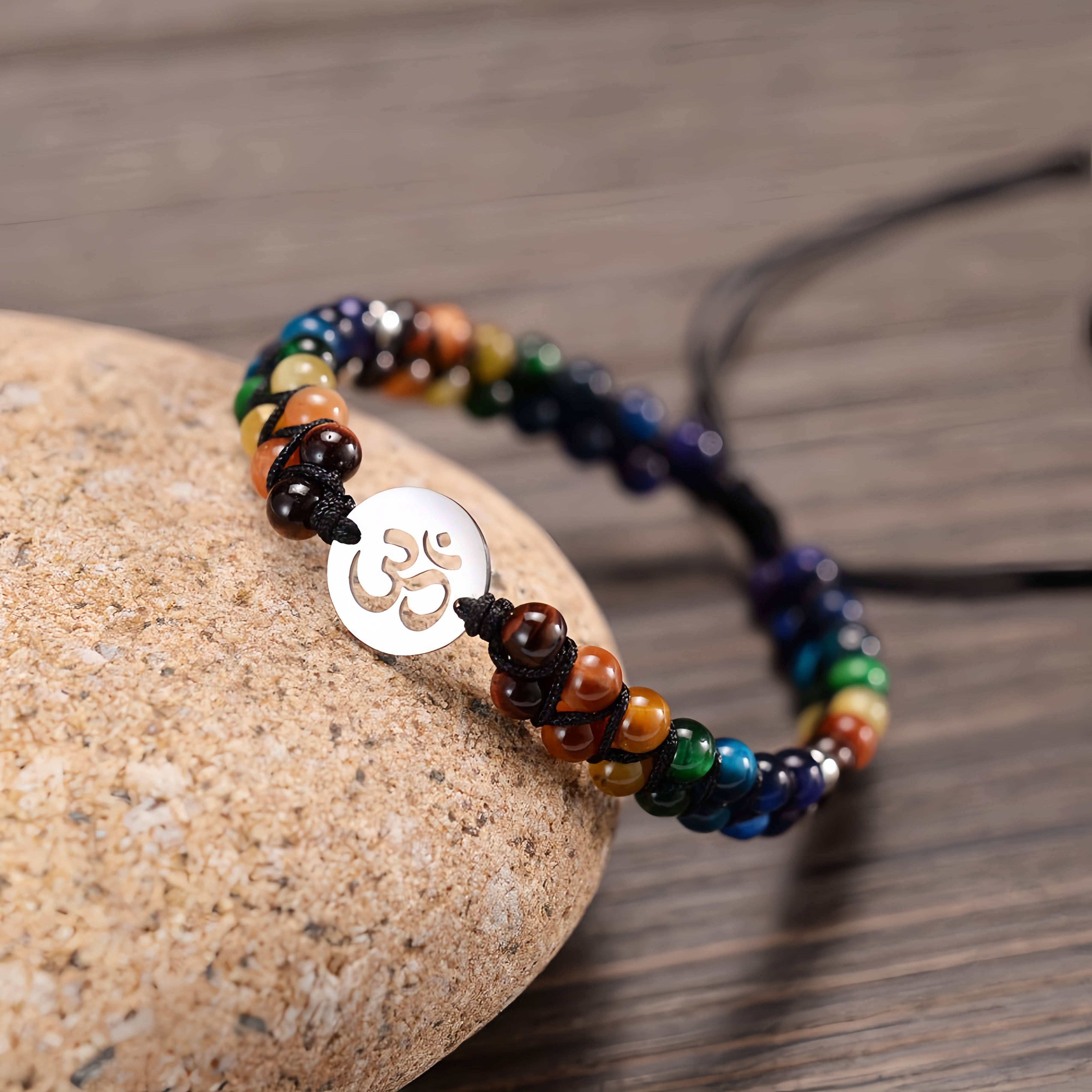Colorful agate chakra bracelet on a stone