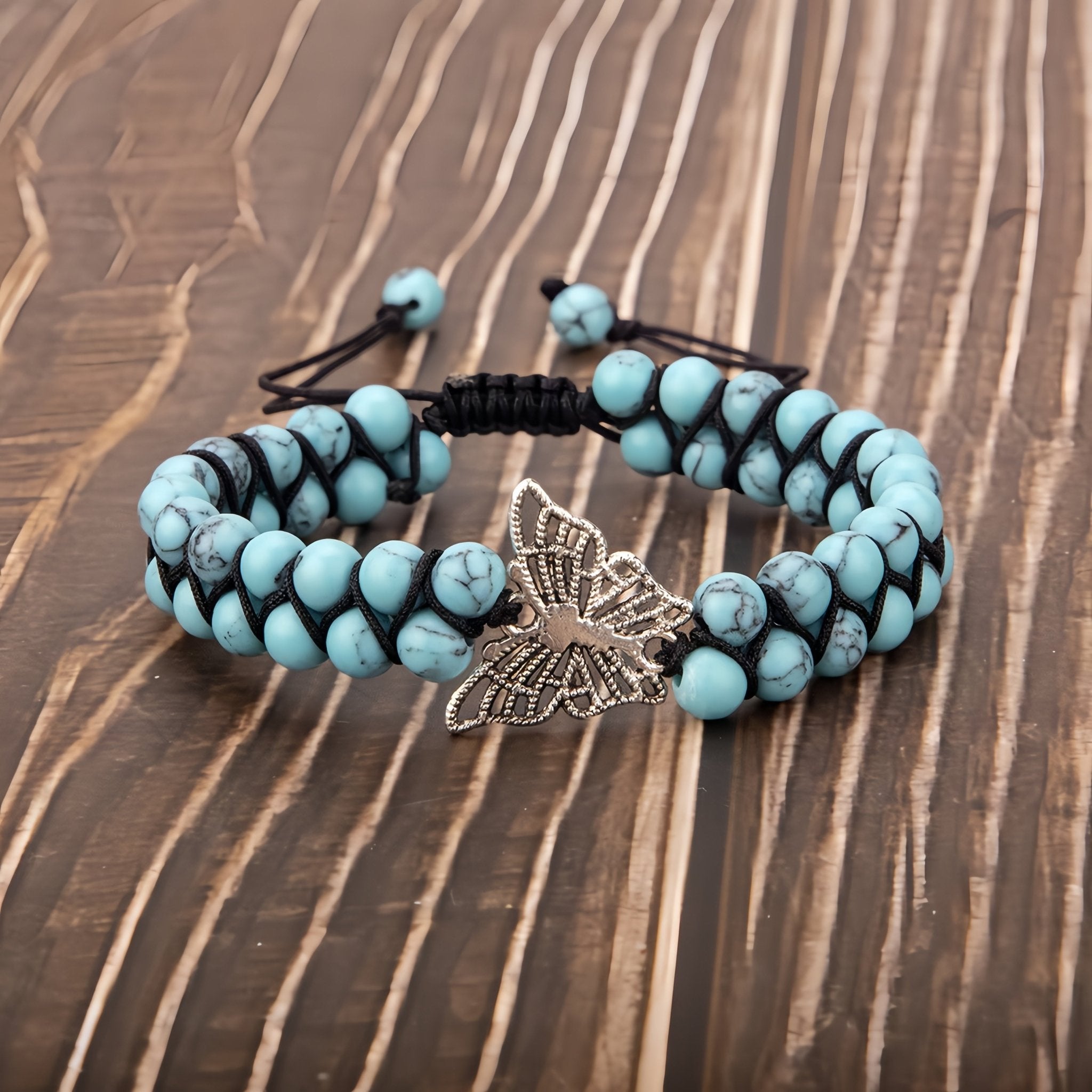 Handcrafted turquoise double-row yoga bracelet, adorned with a silver butterfly charm.