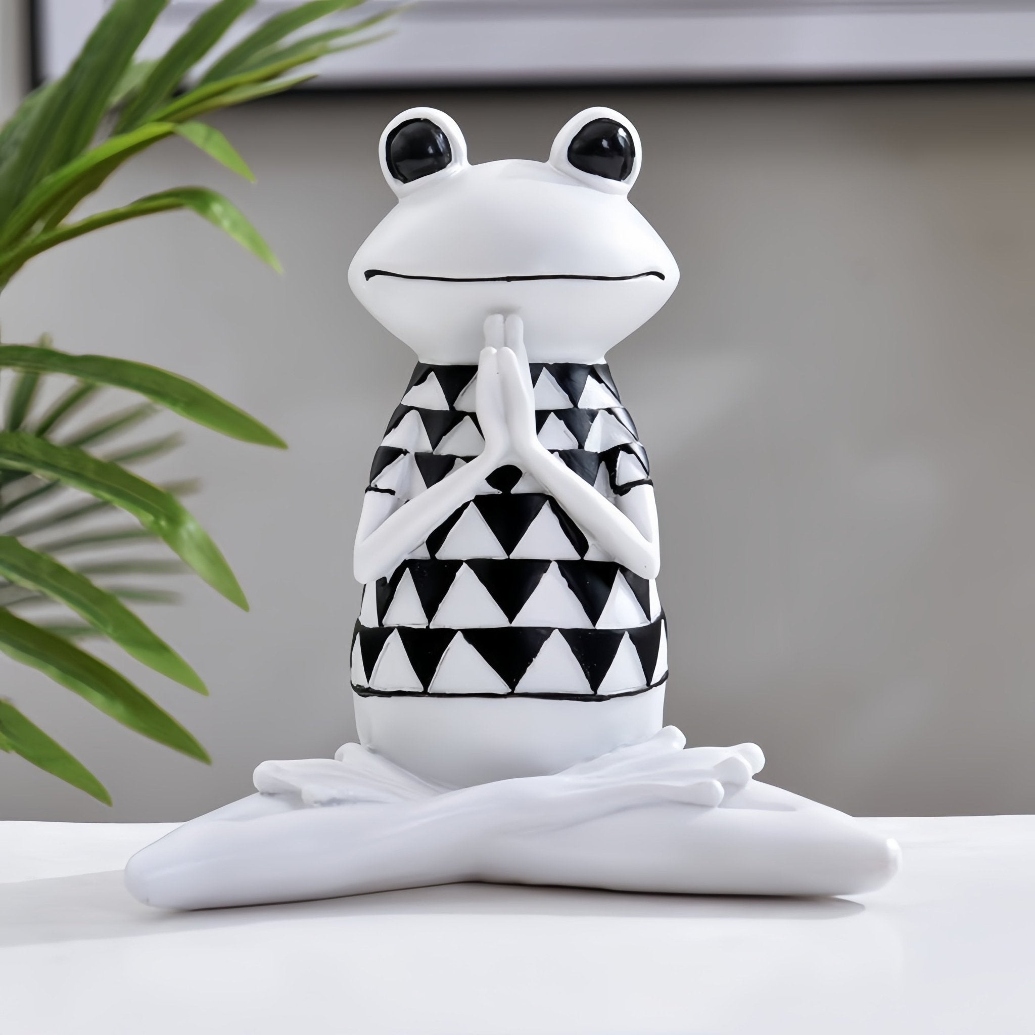 Harmony Zen Frog Statue in a hands-together sitting pose, set against a modern minimalist backdrop.