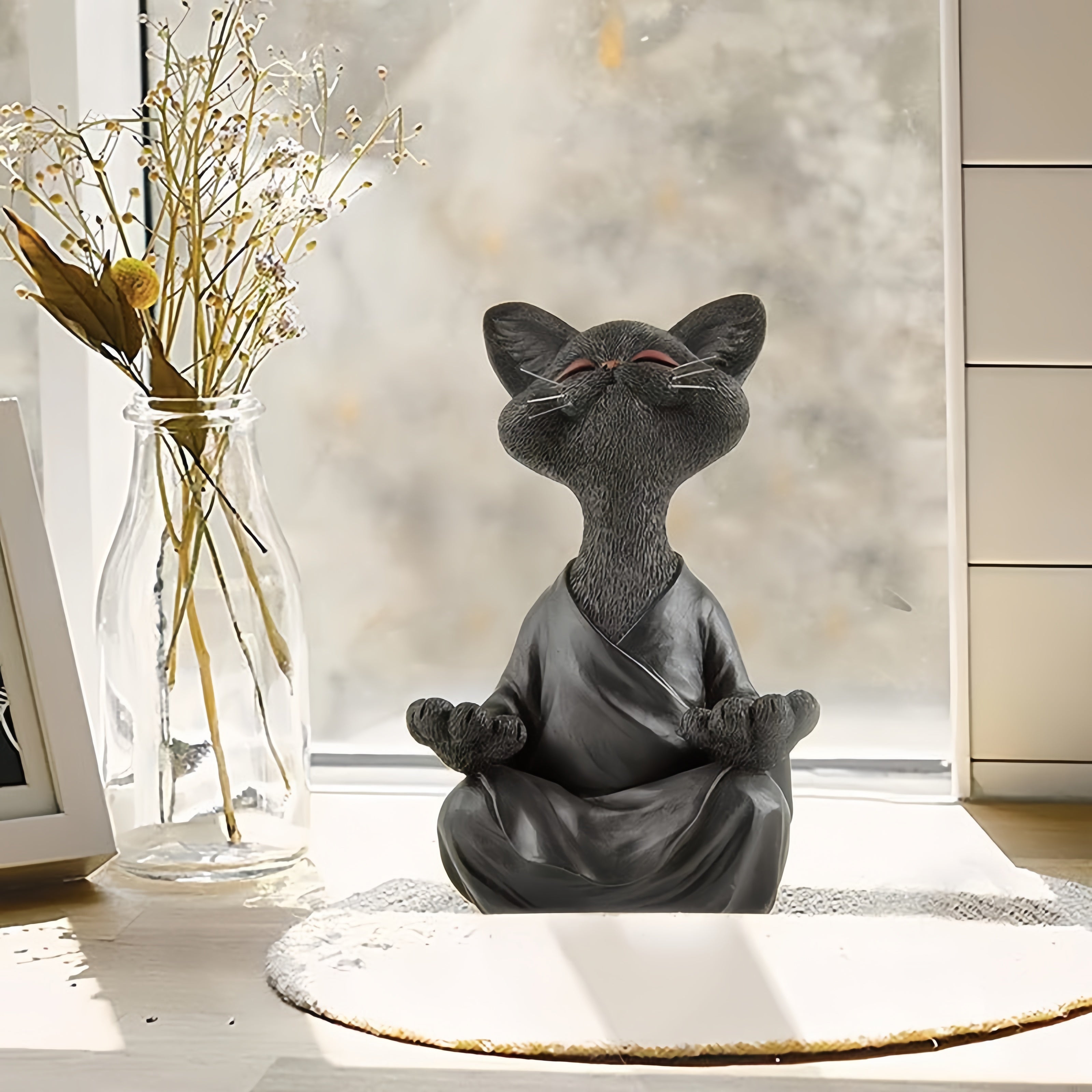 Meditation cat statue in sunlight