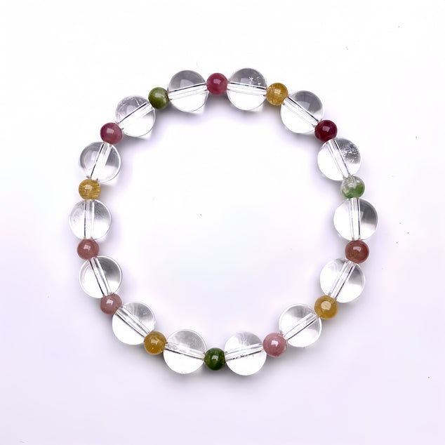 Flat lay of a rainbow tourmaline quartz bracelet, showcasing the varied colors and clarity of the beads.